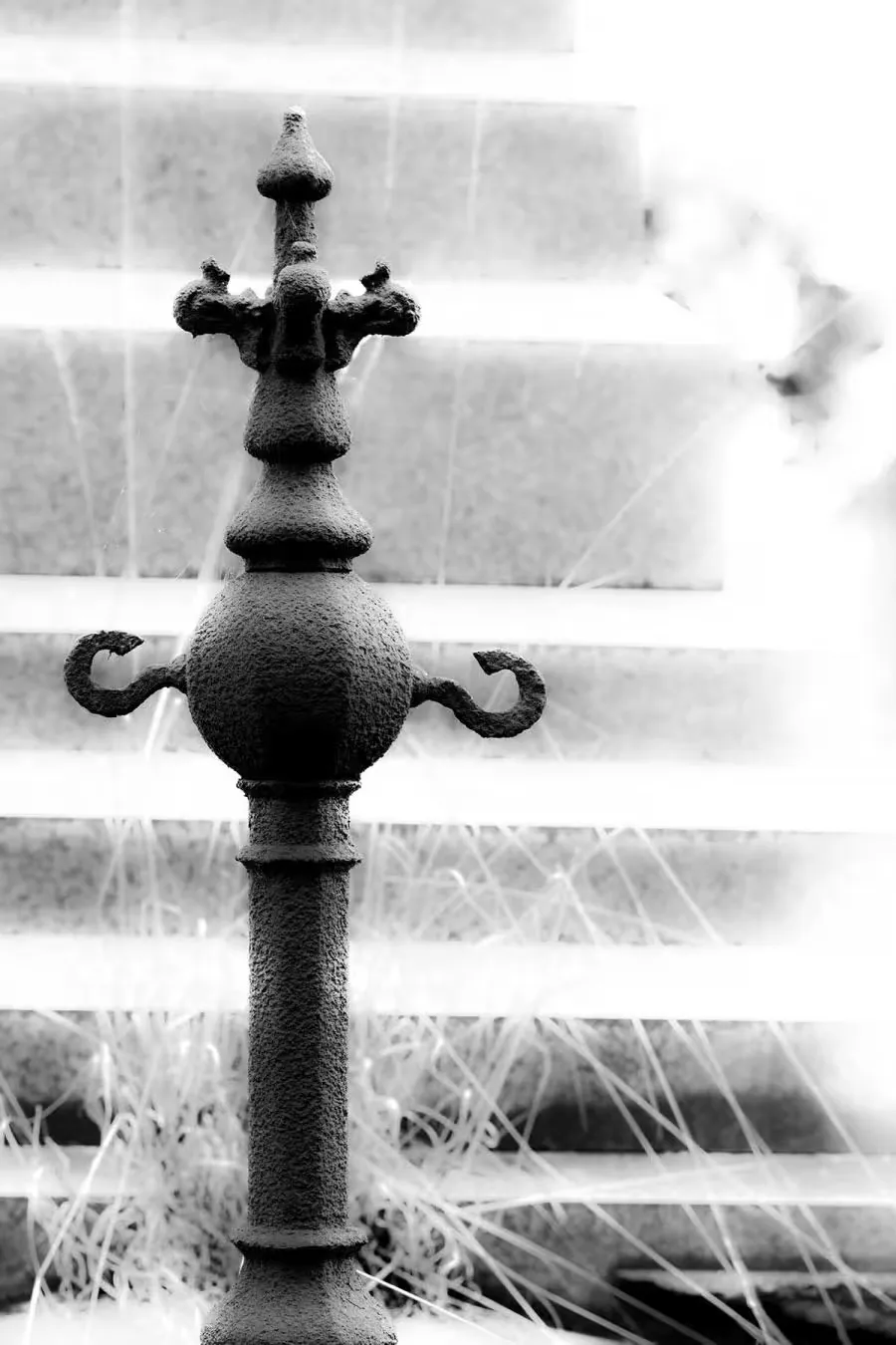 A metal post in front of a stairway