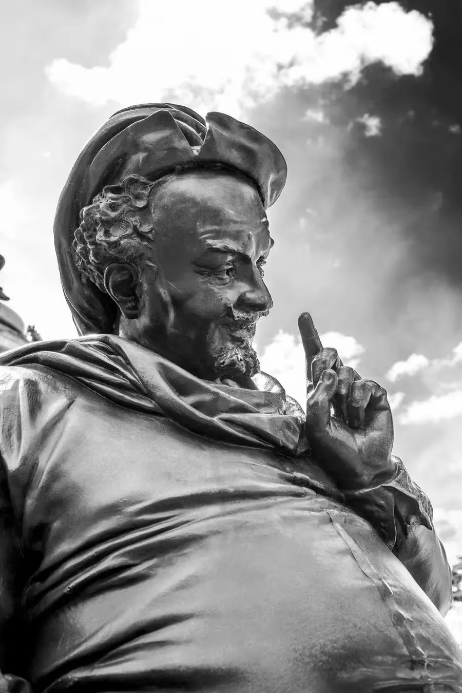 A statue of a man holding up his finger