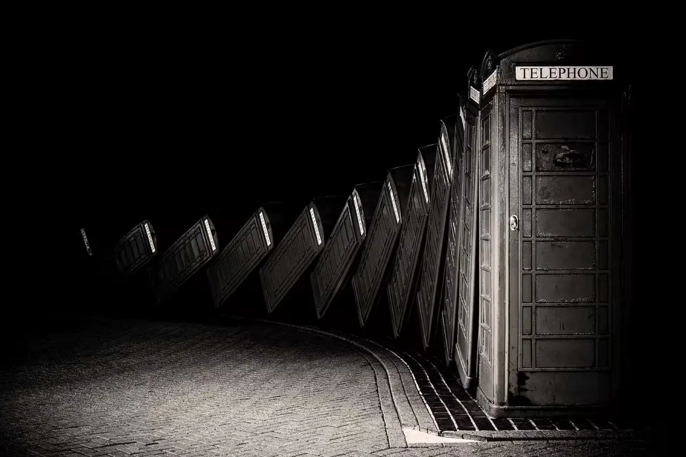 A row of telephone booths leaning against one another